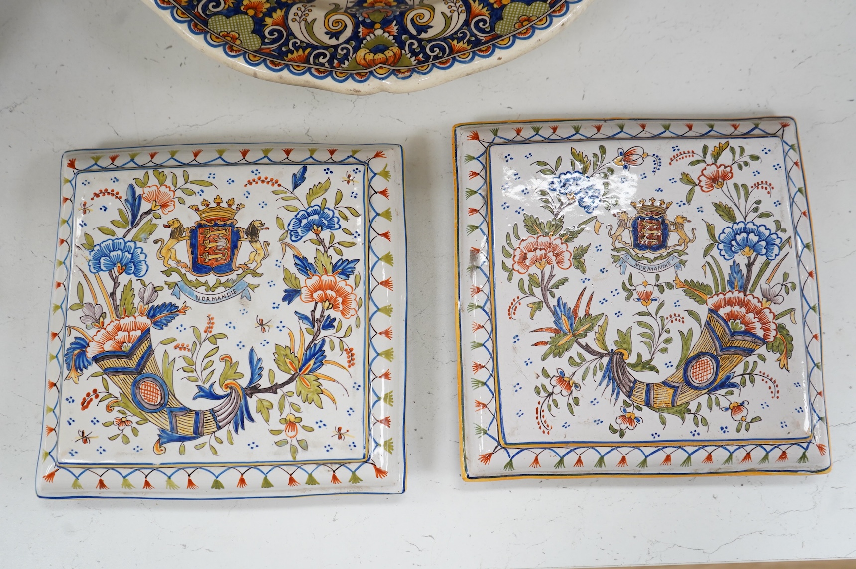 Four various late 19th century French faience dishes/stands, including a Nevers canted rectangular meat dish, largest 46cm wide